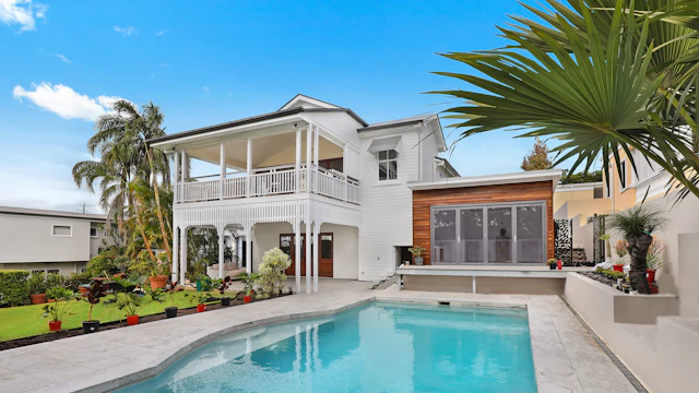 Freshly painted white two-story house with tidy landscaping