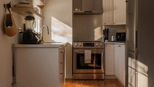 Modern kitchen with stainless appliances and wood floors